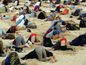 This handout picture taken by Tim Cole and released by 350.org on November 13, 2014 shows Australians burying their heads in the sands of iconic Bondi Beach to send a message to Prime Minister Tony Abbott about the dangers of climate change. As world leaders arrived in the northern city of Brisbane for the G20 summit, more than 100 people dug holes in the famous sand so they could plunge their bodies in halfway, holding their position for three minutes. AFP PHOTO / 350.ORG / TIM COLE   ----EDITORS NOTE ---- RESTRICTED TO EDITORIAL USE - MANDATORY CREDIT " AFP PHOTO / 350.ORG / TIM COLE " NO MARKETING - NO ADVERTISING CAMPAIGNS - DISTRIBUTED AS A SERVICE TO CLIENTS -TIM COLE/AFP/Getty Images